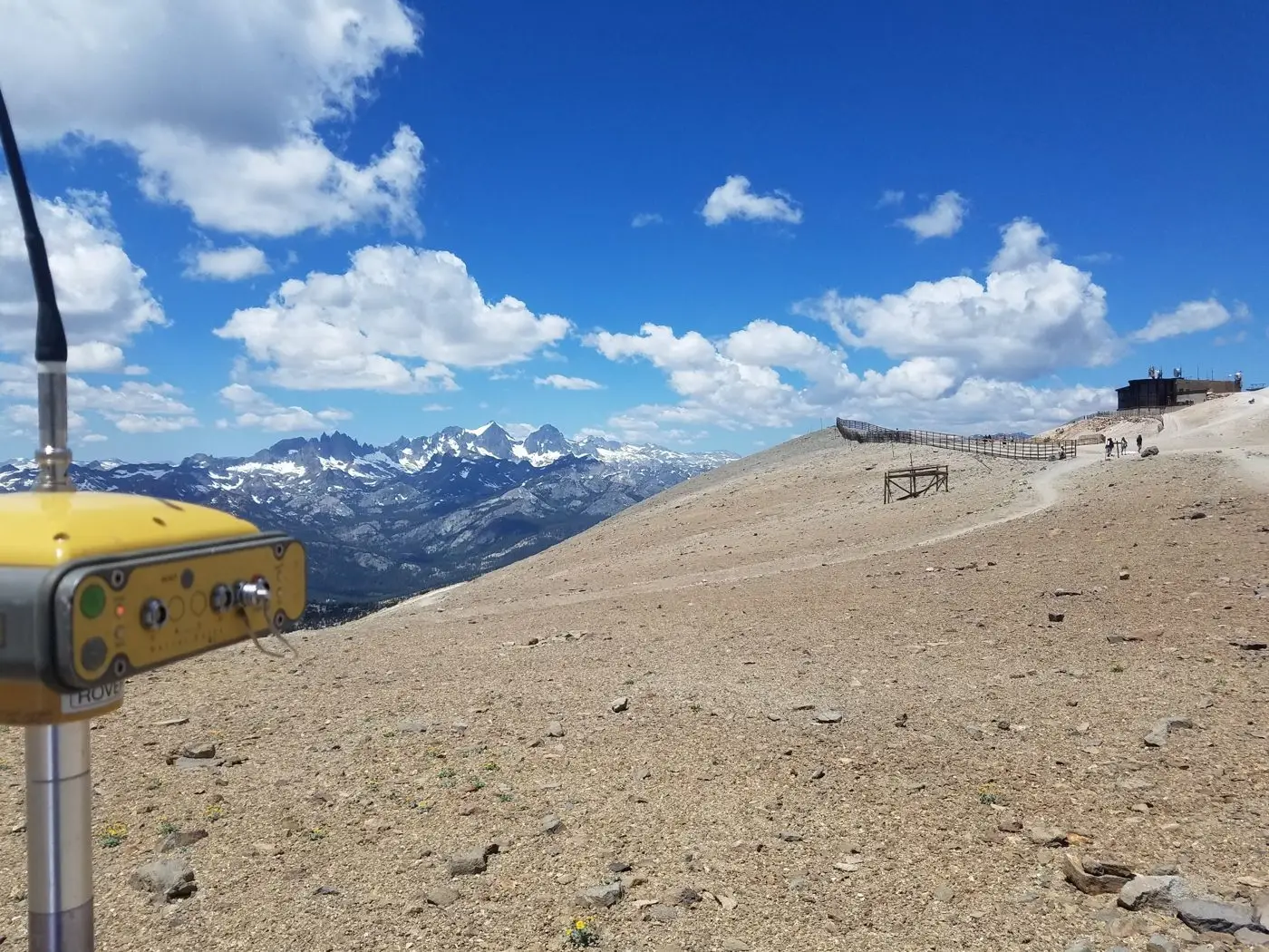 GNSS receiver on the summit of Mammoth Mountain with the Minarets and snowy Sierra peaks behind