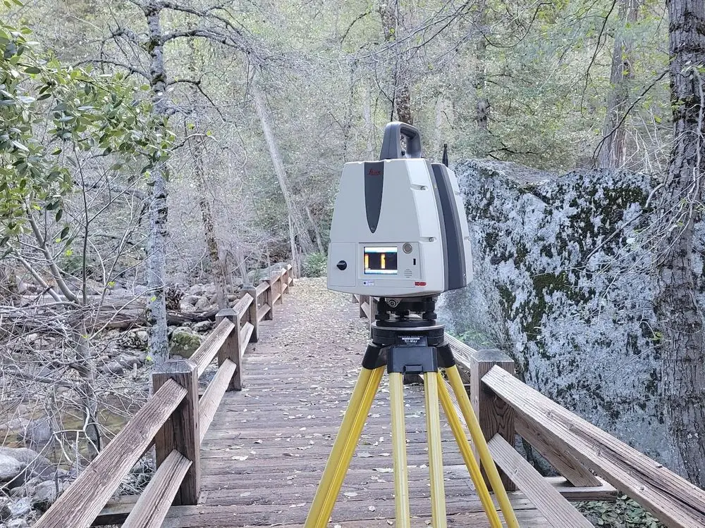 Leica laser scanner on a tripod on a wooden footbridge in Yosemite